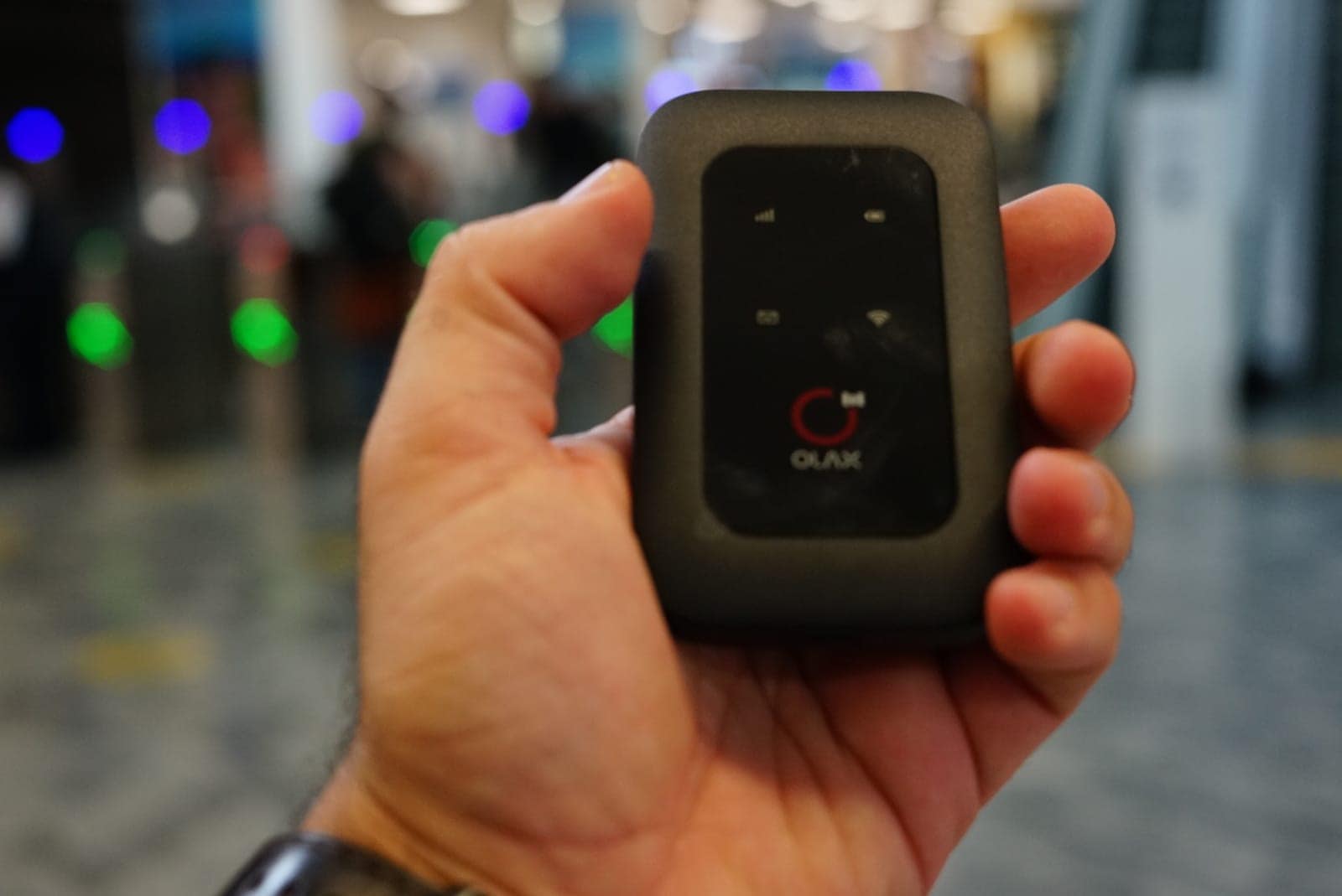 The pocket wifi we rent, held in one hand outside the shop